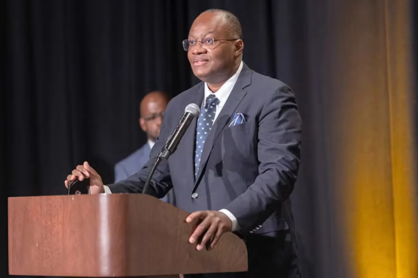 Dr. D. Kojo Hamilton speaking at a podium